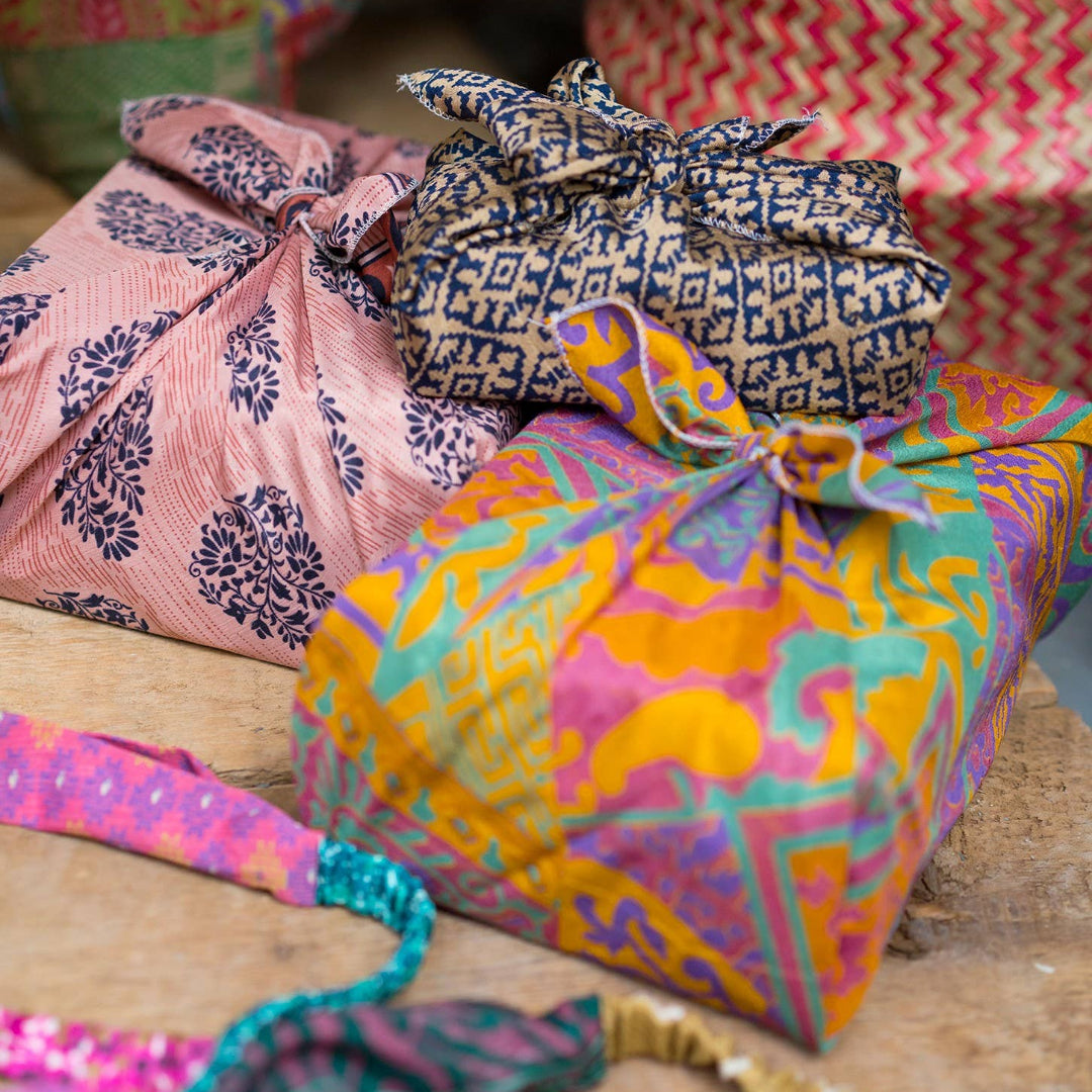 Colorful fabric-wrapped packages on a wooden surface