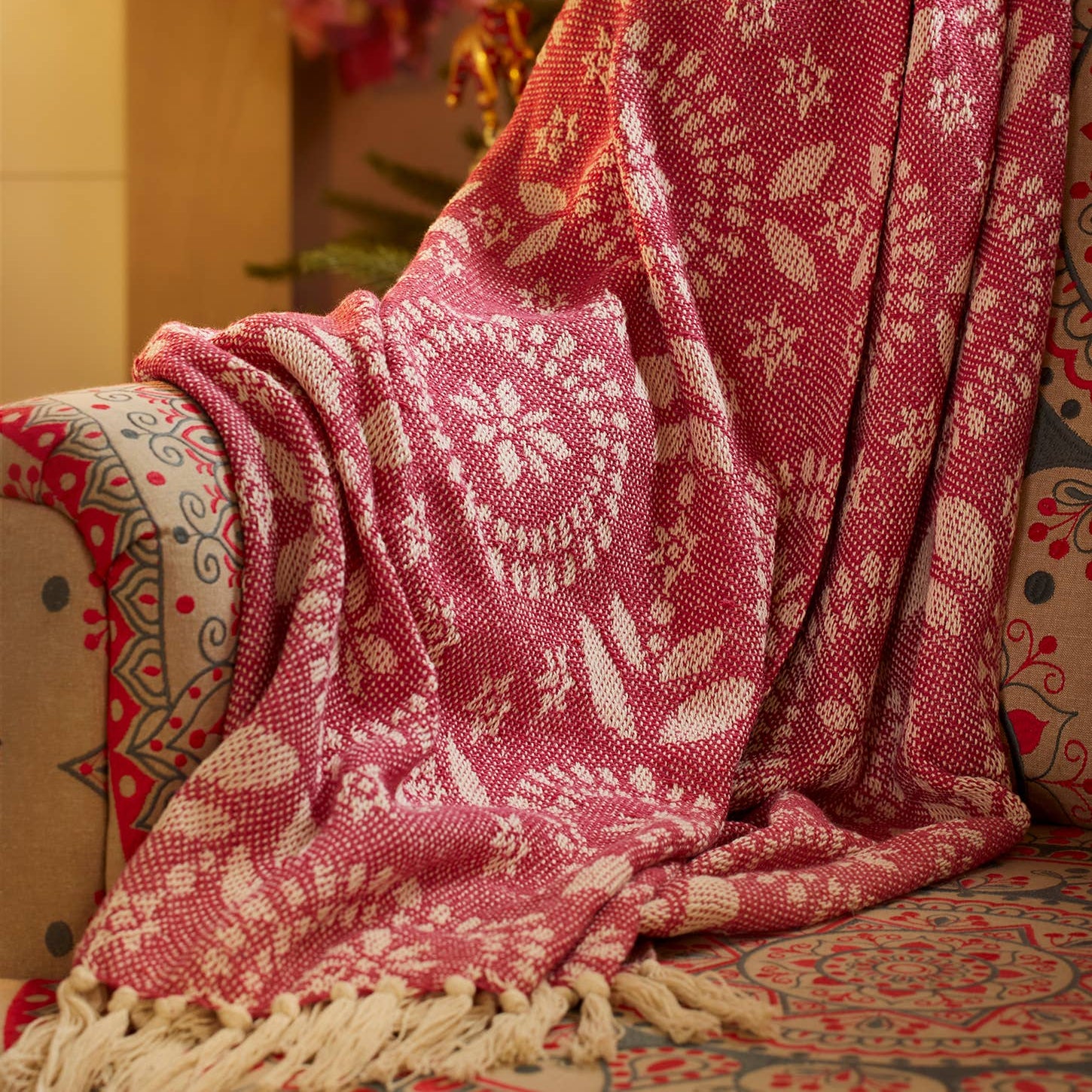 Pink patterned blanket draped over an armchair