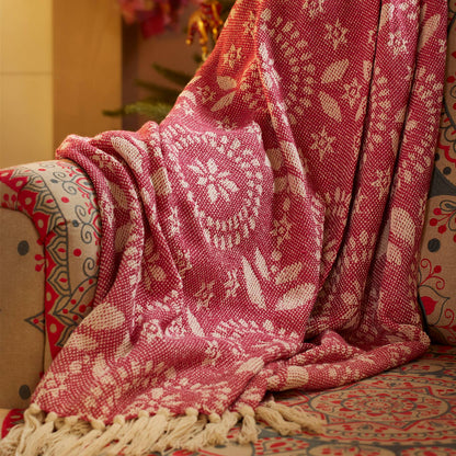 Pink patterned blanket draped over an armchair