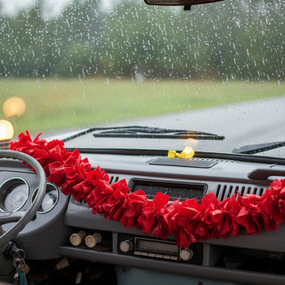 Red ruffled fabric garland on a campervan dashboard.