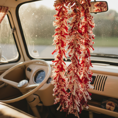 Red and white tinsel garland shown hanging inside campervan cab