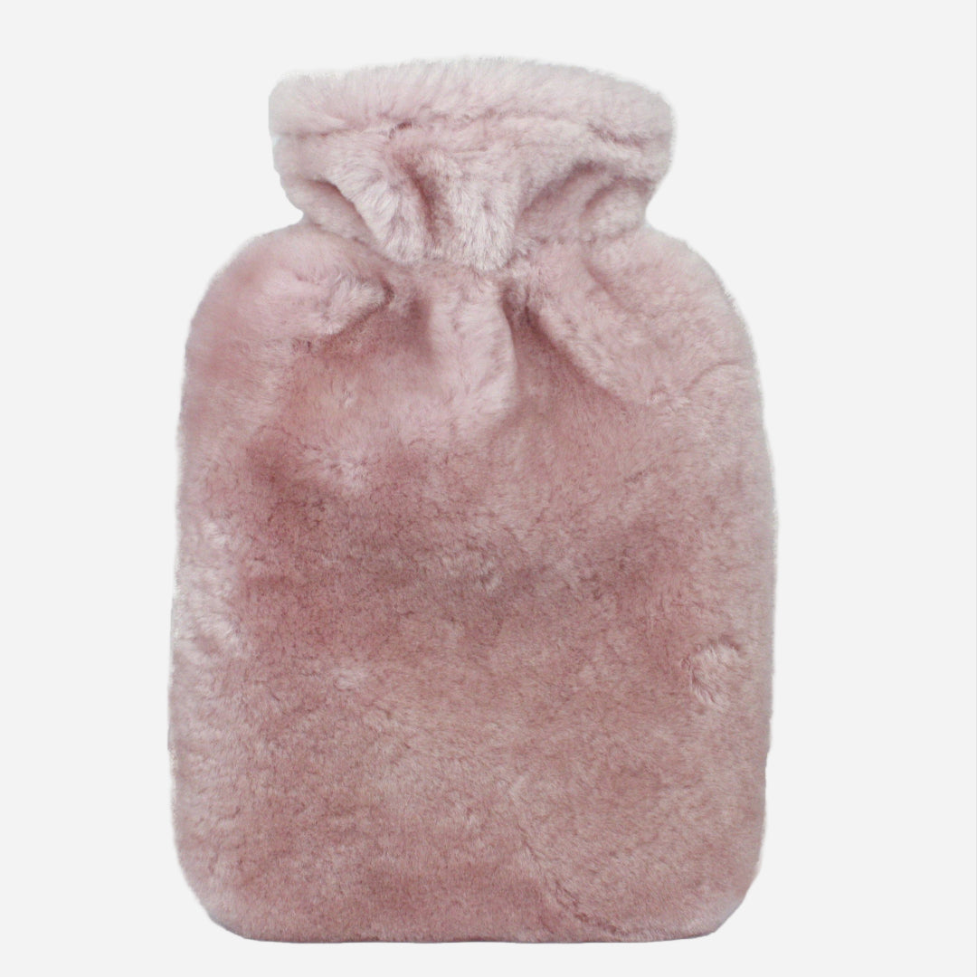 rose pink sheepskin hot water bottle on light grey background