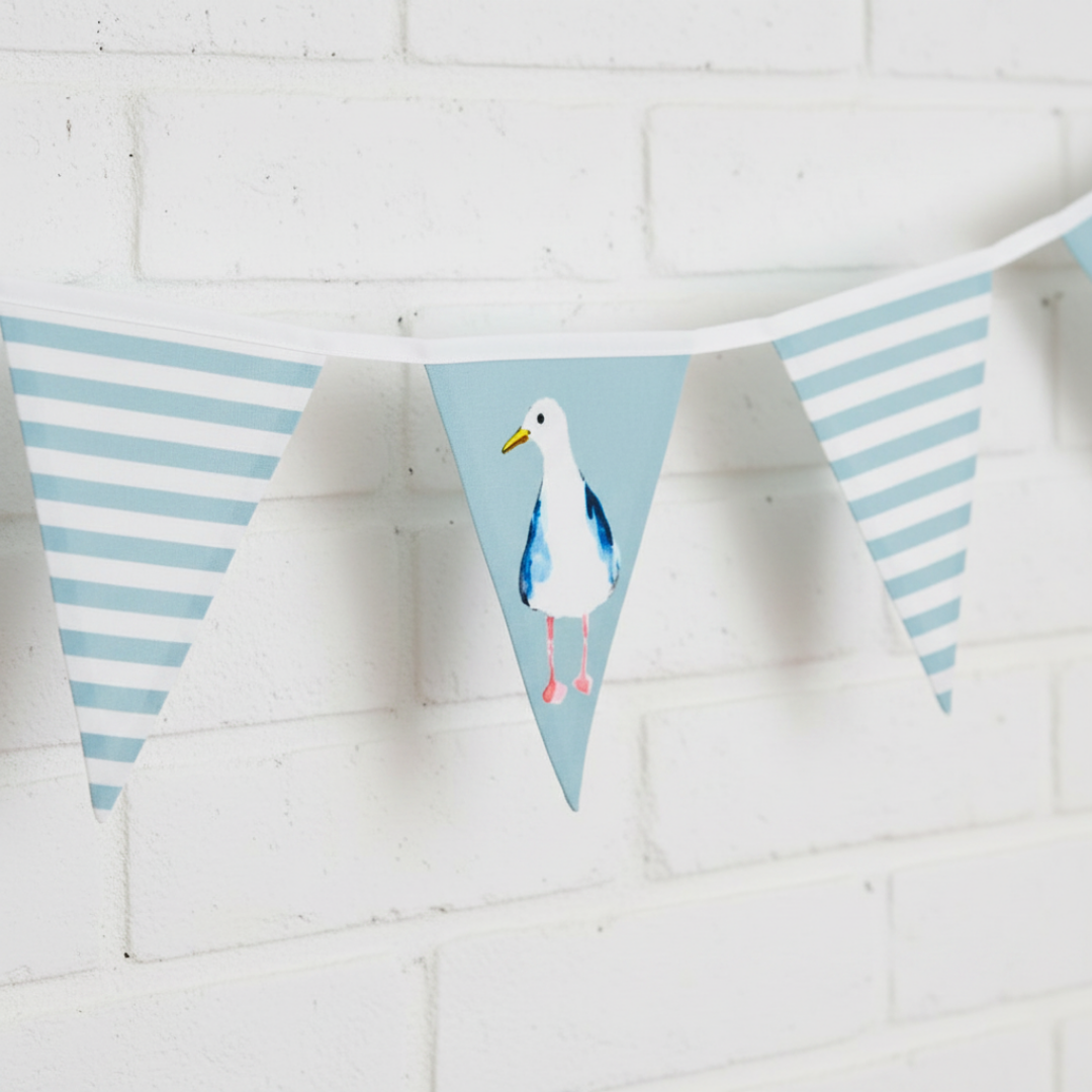 Bunting with seagull design on a white brick wall background