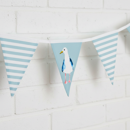 Bunting with seagull design on a white brick wall background