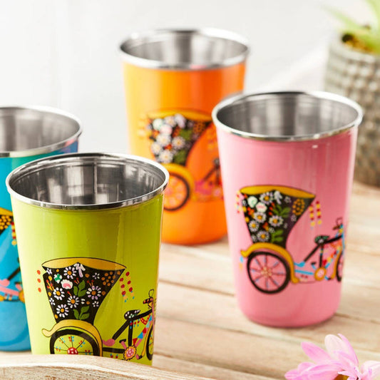 Set of three colourful stainless steel tumblers with rickshaw designs displayed on a wooden tray.