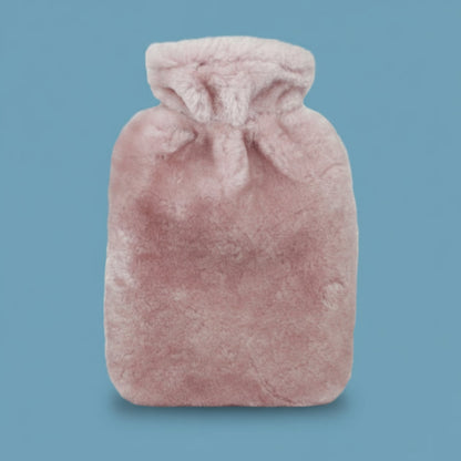 Pink sheepskin hot water bottle on a white background