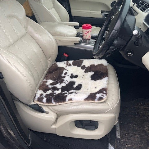 campervan interior with a sheepskin seat pad on the driver's seat