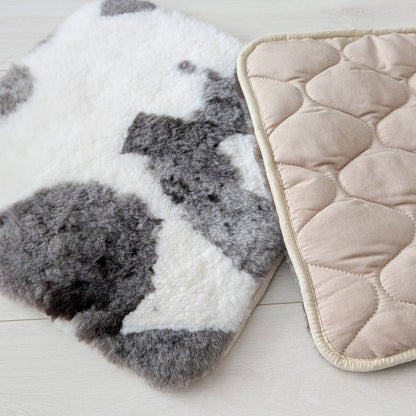 two natural sheepskin seat pads, one showing quilted underside