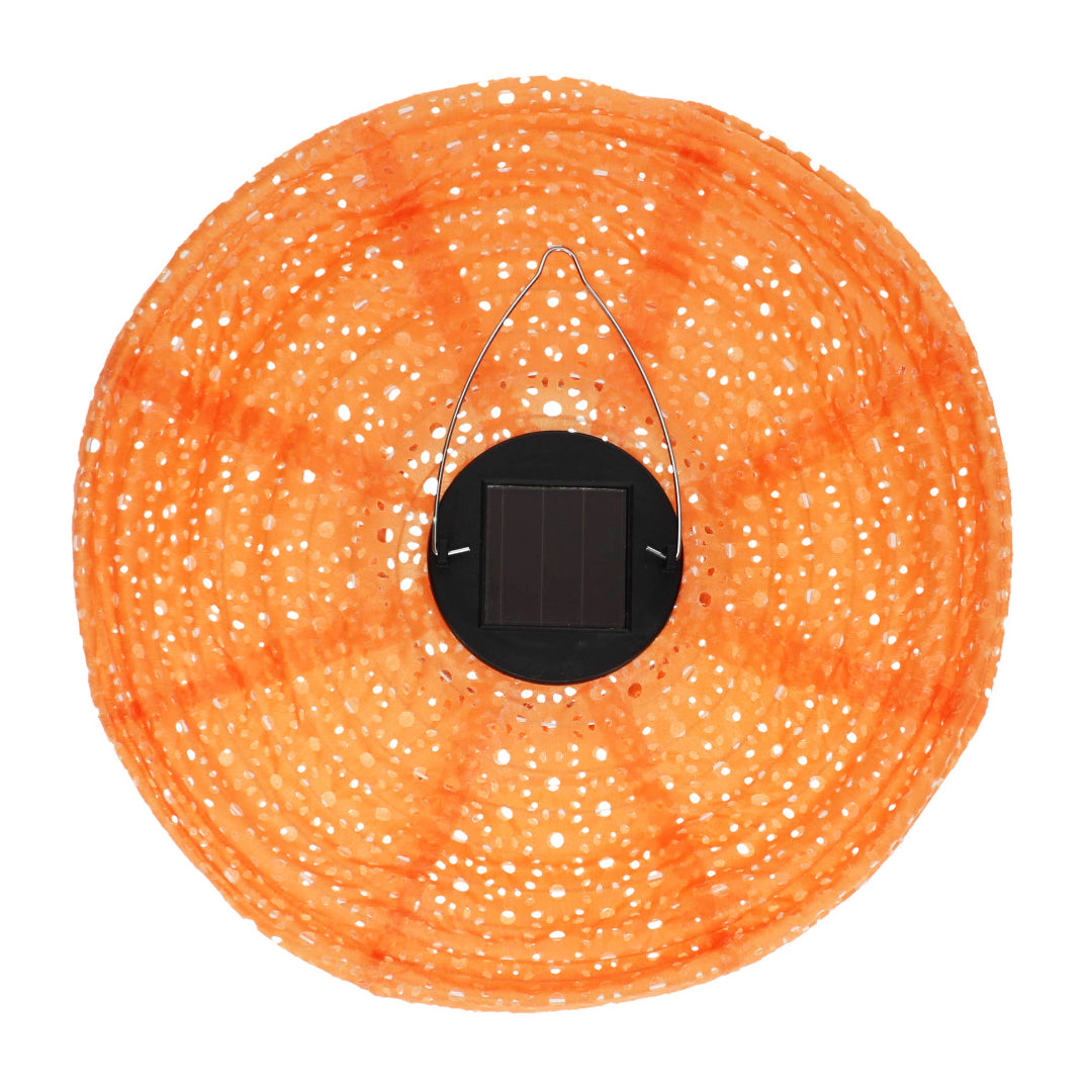 orange solar lantern photographed from above showing solar battery in the middle