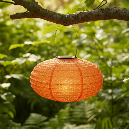 Orange fabric lantern on a green background