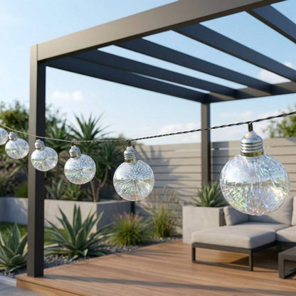 Decorative string lights hanging from a pergola on an outdoor patio in sunny garden.