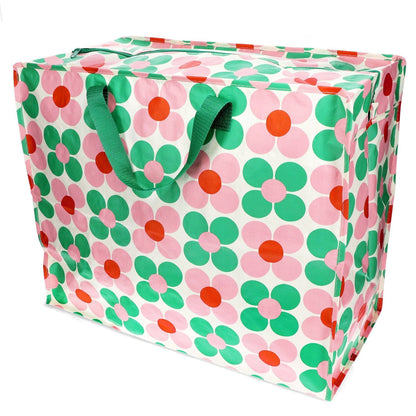 Floral-patterned storage bag with green handles on a white background