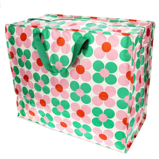 Floral-patterned storage bag with green handles on a white background