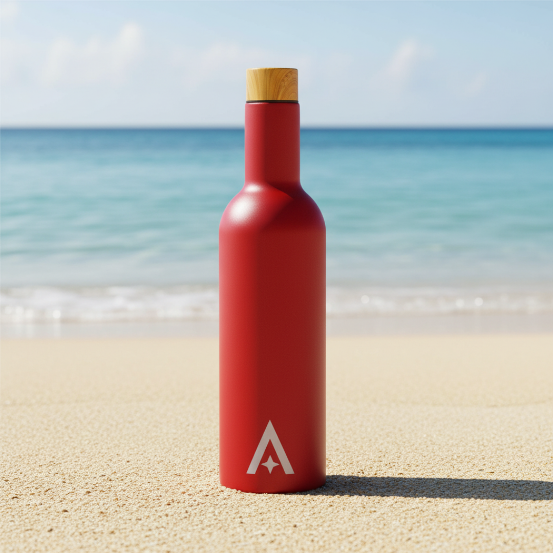 Red insulated wine bottle with a cork cap on a beach background