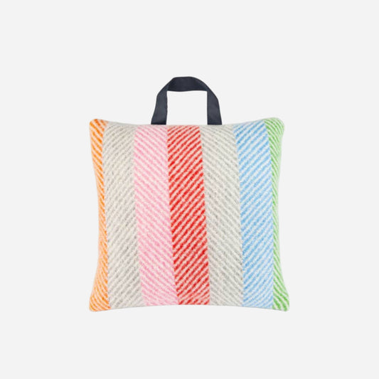 Colorful striped pillow with a handle on a white background
