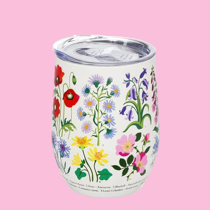 white travel mug with wild flowers design on pink background