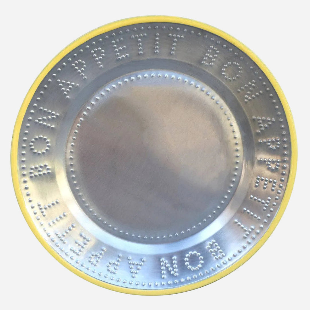 stainless steel plat with embossed text "Bon Appetit" with yellow trim on a white background